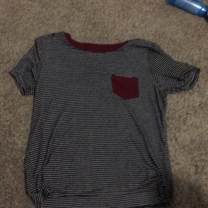 Black and white striped t shirt with a red pocket